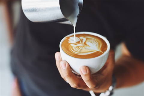 Barista-pouring-milk-into-a-freshly-brewed-coffee.jpg